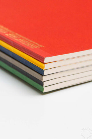 STÁLOGY 016 B5 notebooks stacked, showing red, yellow, blue, gray, and green covers