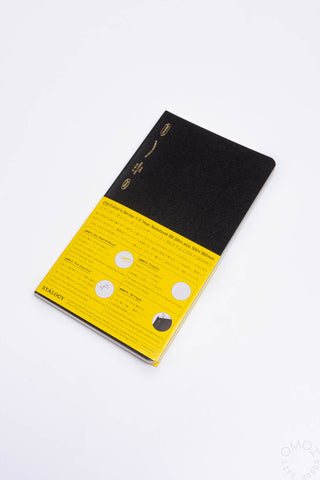 Black slim notebook with yellow cover band and rounded corners