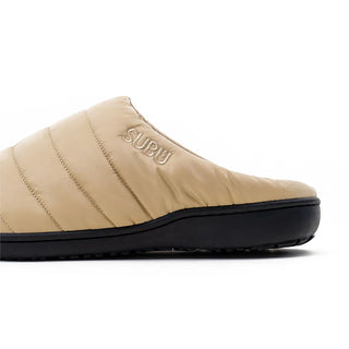 Beige quilted SUBU slip-on slipper with logo and black outsole, side view