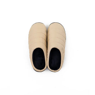Beige quilted slip-on slippers with black-lined openings, front view