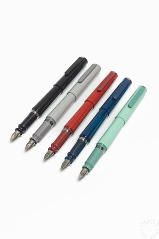 Assorted fountain pens in black, red, blue, green, and translucent violet colors