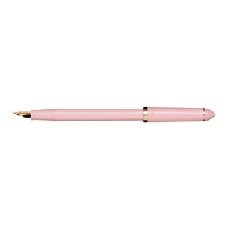 Pearl pink fountain pen side view with pointed gold nib and clip detail