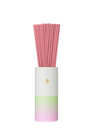 Gradient incense canister filled with pink incense sticks bundle