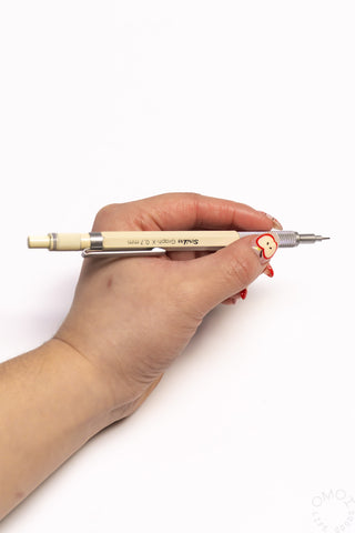Cream mechanical pencil with 0.7mm tip, shown in a hand