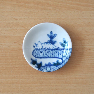 Small ceramic mini plate with blue wave seigaiha and sleeping dino illustration