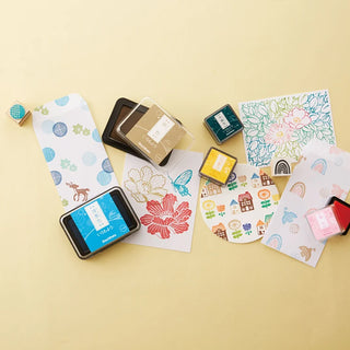 Set of various colored stamp ink pads with labeled lids on cards