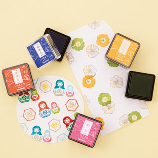Mini stamp ink pad set with multiple colored ink cubes and patterned stamp sheets