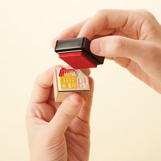Shachihata mini stamp ink pad with red ink, held between hands