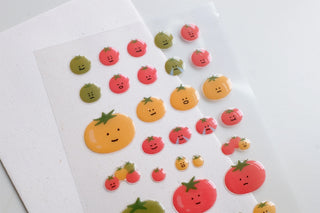 Glossy puffy tomato and fruit stickers with smiley faces, varied sizes and shapes