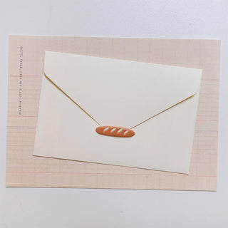 Single puffy sticker with brown oval pastry design on white card