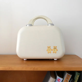 White suitcase with two bear figure stickers on the front