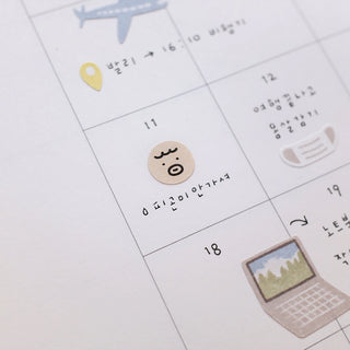 Smiley face sticker on a grid planner page, with additional small icons