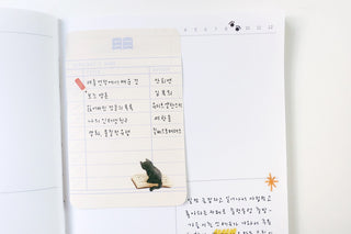 Cat sticker on notebook page with handwritten notes