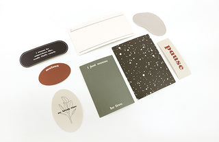 Assorted sticker pack pieces with round and rectangular designs, including 'Pause'