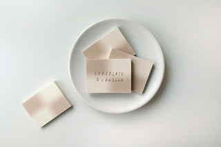 Cream sticky memo note blocks stacked on a white plate