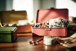 Live coral stackable storage box open with carry handle, holding small items