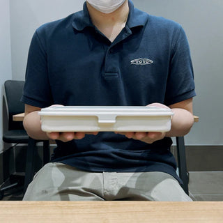 Red trunk toolbox case held in hands by a person