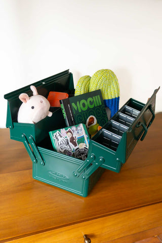 Antique green cantilever toolbox open with internal compartments and dividers