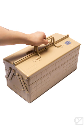 Beige cantilever toolbox with hand grasping top handle