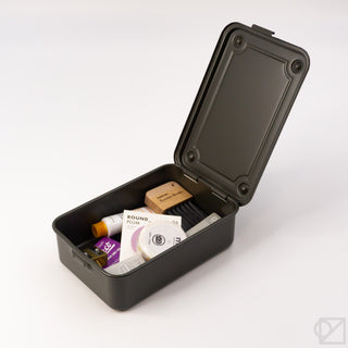 Olive green storage box with lid open, showing interior and packaged items