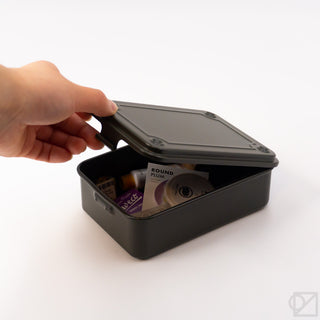 Olive green storage box with lid open as a hand lifts the latch