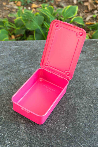 Shocking pink trunk-shaped toolbox with open lid and inner tray