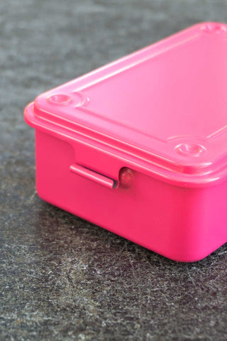 Shocking pink trunk-shaped toolbox side view with metal latch/handle