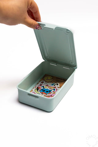 Glacier blue stackable storage box open with latch, holding colorful cards