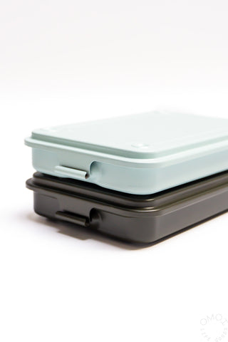 Stacked trunk-shaped toolboxes, light blue lid on dark base