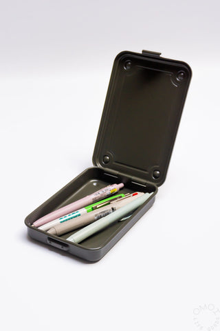 Open olive green trunk-shaped toolbox with hinged lid and pens/pencils inside
