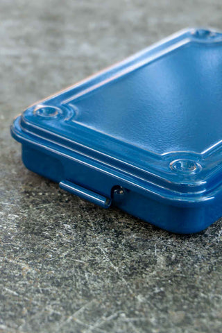 Navy trunk-shape metal toolbox close-up of lid and latch