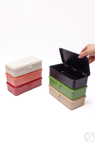 Stackable storage boxes with hinged lids open; red, dark green, and cream colors