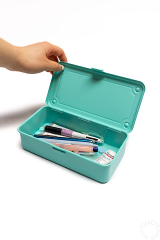 Emerald green storage box with lid open, showing stationery inside