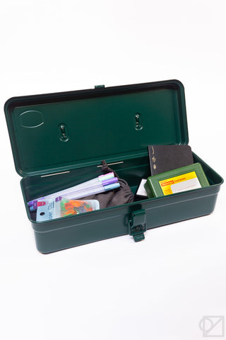 Antique green trunk-shaped toolbox open, showing tools and papers in compartments