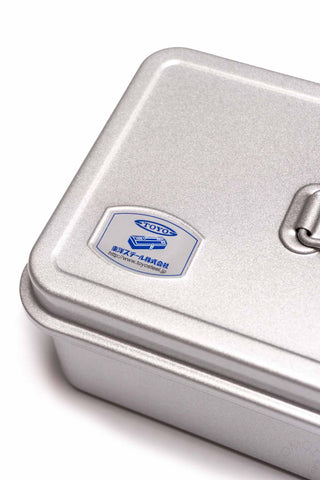 TOYO STEEL logo on silver toolbox lid with metal latch on right