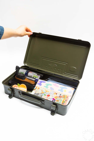 Olive green trunk toolbox open, lid held up; twin latches with tools and accessories inside.