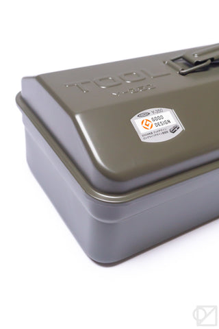 Olive green toolbox corner detail with embossed lid text and sticker label