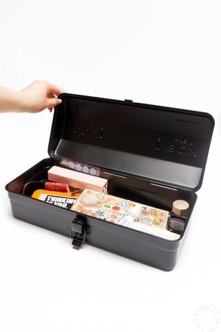 Black Y-350 toolbox open with tray and latch, hand lifting lid