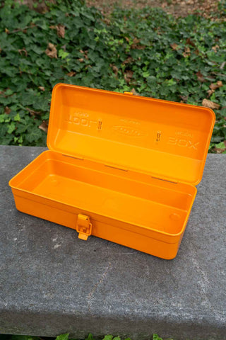 TOYO STEEL orange toolbox with open lid and interior tray, front latch visible