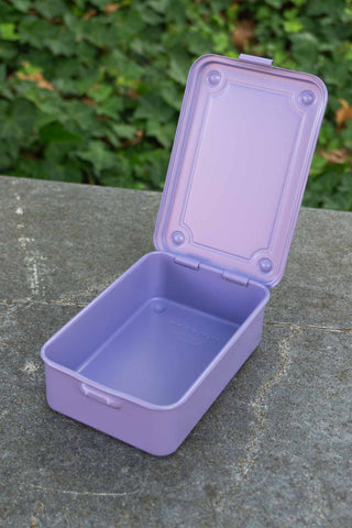 Lilac trunk-shaped toolbox with open hinged lid and empty tray interior