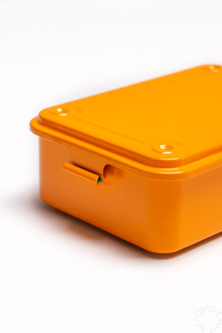 Orange trunk-shape toolbox lid close-up with latch opening and corner screws