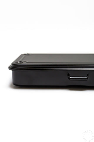 Black trunk toolbox side view with molded carry handle detail.