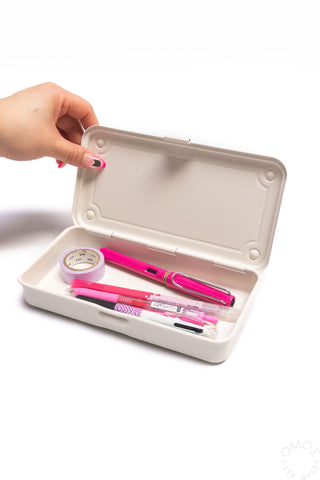 Trunk-shaped toolbox, off-white open lid with stationery and tape inside.