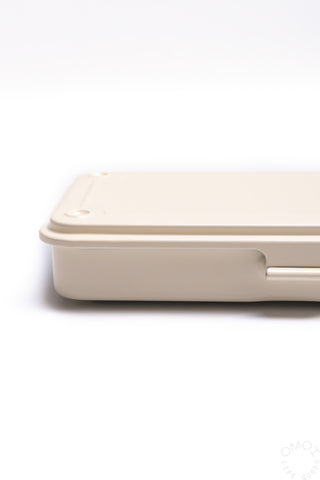 Trunk-shaped toolbox, off-white side profile with latch and molded handle section.