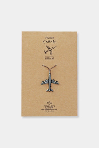Metal pewter airplane charm with loop, shown on kraft backing card.