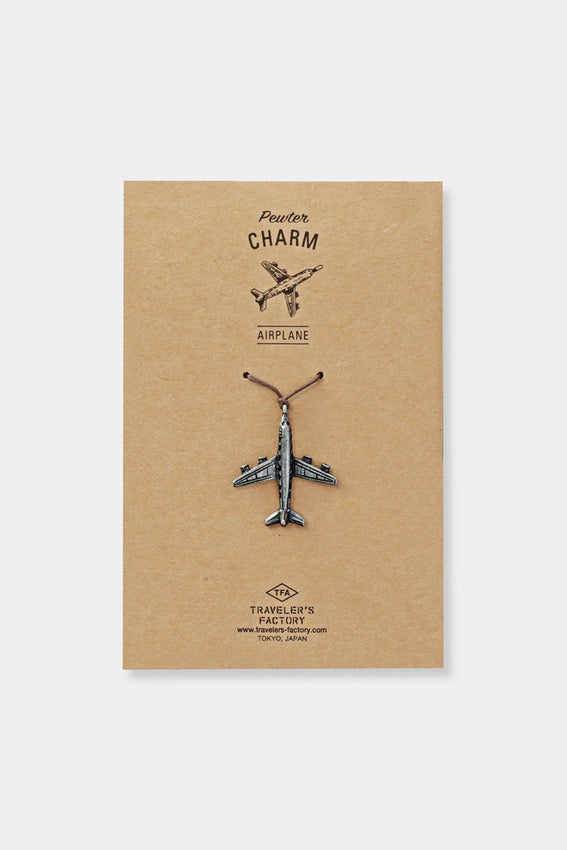 Metal pewter airplane charm with loop, shown on kraft backing card.