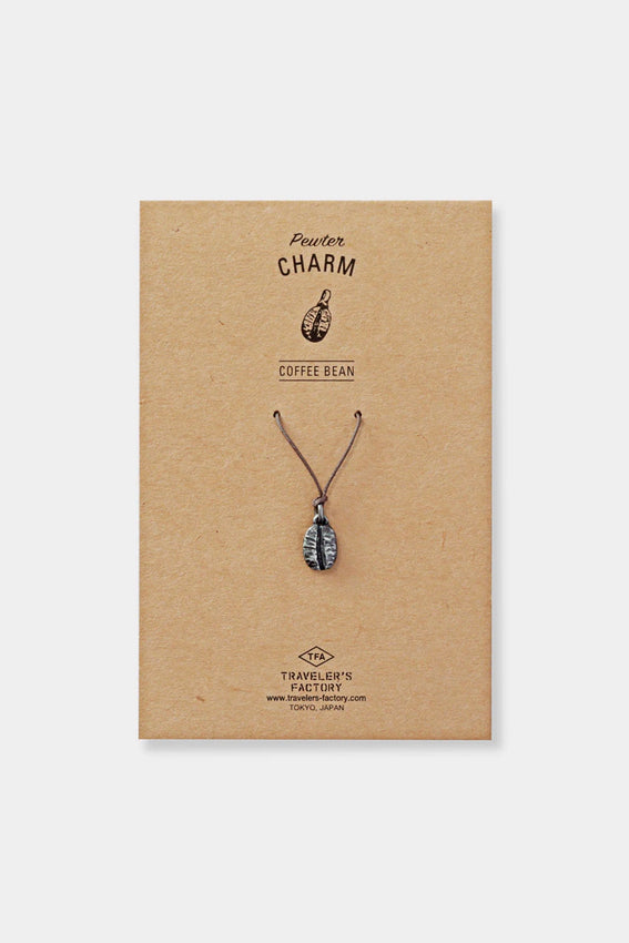 Pewter coffee bean charm on display card, with cord loop at the top