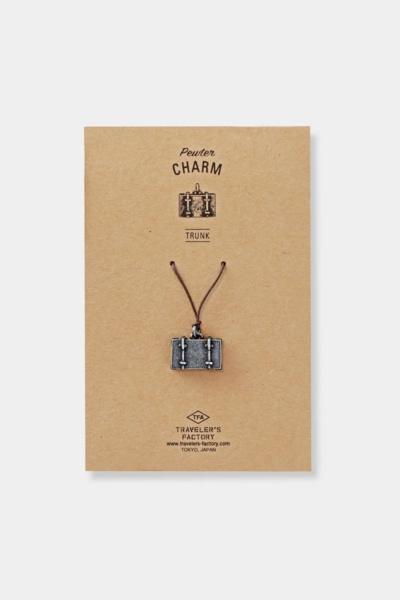 Pewter trunk charm on cord, shown on Traveler's Factory card