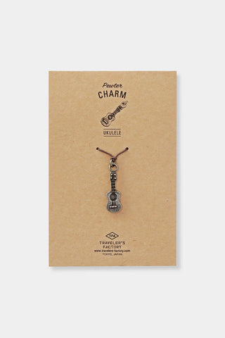 Pewter ukulele charm on kraft display card with brand text