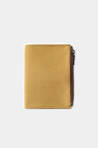 Beige passport-size cotton zipper case with stitched front flap, closed view.